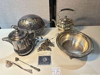 Group shot showing all eight silver plated items