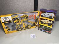 Front of CAT Construction Site Mega Set box beside Adventure Force 3-pack package