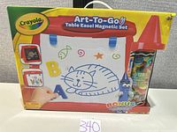 Front of sealed box showing Crayola Art-To-Go Table Easel Magnetic Set