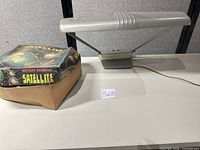 Lamp and boxed Satellite toy on table
