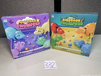 Front view of Unicorn Chompers and Dinosaur Chompers boxed games