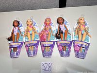 Front view of five sealed Hairmazing swim dolls