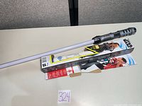 Lightsaber with box on tabletop