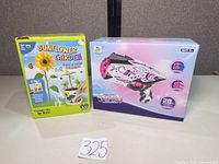 Front view of both boxed items showing branding and age recommendation