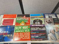 Nine record jackets laid out showing mix of Christmas, soundtrack and compilation titles