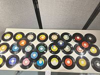 Overview of all 28 vinyl singles arranged on table