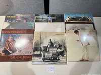 Overview of all eight album covers laid out on table