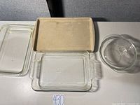 Group shot of all four items: two glass rectangular dishes, one glass mixing bowl, one stoneware tray