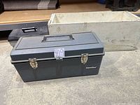 Gray International plastic toolbox, off-white wood crate behind
