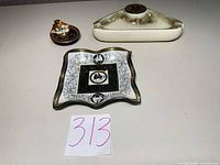 Overview of three dishes laid out on surface with lot number 313 visible