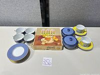 Group view of all teacups, saucers, covered dishes and Girolle slicer box