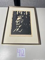 Full view of framed woodcut print with frame and mat