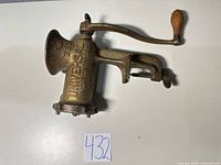 Full view of grinder showing model, brand, clamp and crank