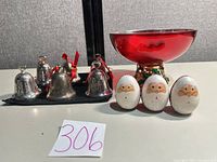 Group shot of six bells, red glass bowl, three wooden Santa eggs