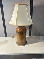 Full view of lamp showing base, shade, cord