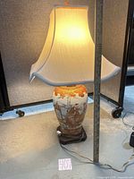 Full lamp with shade beside ruler showing height