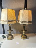 Front view of both brass table lamps with shades