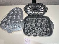 All three pans laid out: acorn mold, Bundt pan, 12-cavity ring pan