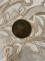 Obverse of 1806 penny showing bust of King George III with corrosion