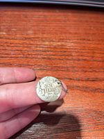 Obverse side of drilled 1920 Canada one-cent coin with loop