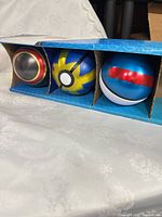 All three sealed Poké Balls in sleeve