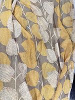 Close-up of botanical leaf pattern on sheer curtain fabric