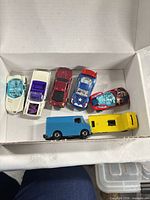 All seven die-cast vehicles inside box