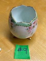 Full view of porcelain rose bowl showing exterior floral design and feet