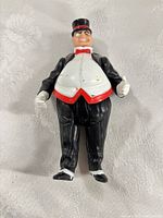 Front view of The Penguin action figure showing tuxedo, bow tie, limb articulation and paint wear