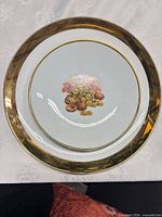Plate with grapes, walnuts, wide gold rim