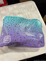 Front view of fabric pouch showing gradient colour and heart pattern