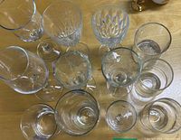 Top-down view of all 12 glasses showing variety of sizes and styles