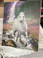 Front view of laminated print showing horse, waterfall, and forest scene