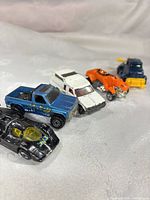 Group of five Hot Wheels cars showing overall mix