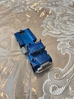 Blue Peterbilt semi-truck cab, paint chips visible