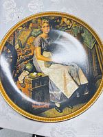 Front view showing Rockwell artwork and gold rim