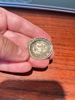 Obverse of worn coin with visible inscription