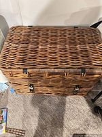 Closed rectangular wicker basket with lid and clasps