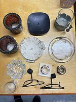 Overhead view showing all twelve candle holders, plates and brackets on table