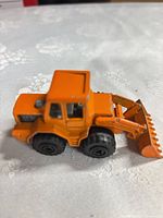 Orange die-cast front loader side view
