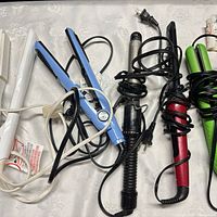 Group shot of six corded hair tools on table