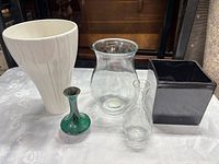 Group shot of five vases and planters on table