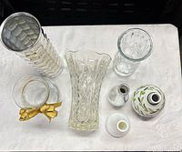 Top-down view of all six vases showing sizes, shapes, and materials