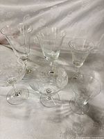 Six clear etched floral stemware pieces grouped