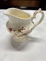 Side view of Myott Heritage floral porcelain creamer