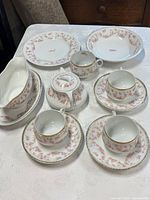 Full group of tea set pieces on table