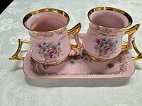 Both pink pitchers sitting on matching tray showing overall set