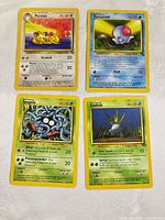 Group shot of all four Pokémon cards spread out