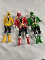 Front view of Yellow, Red and Green Power Rangers Samurai action figures