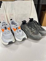 Both pairs of sneakers side by side showing overall condition and colors